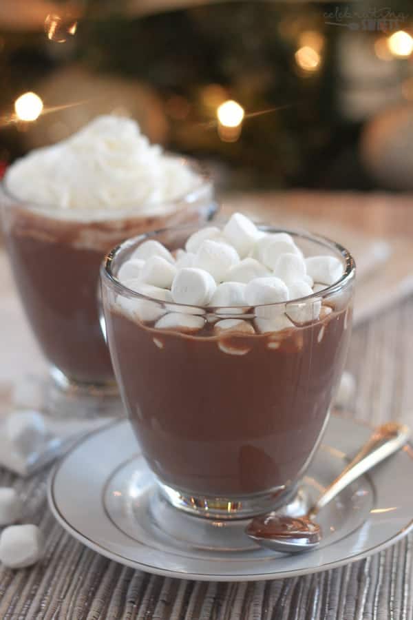 Hot chocolate in a glass topped with marshmallows.